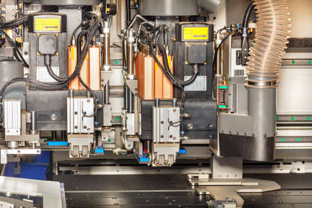 A fragment of the platform of a modern woodworking machine with electronic clamping mechanisms and...