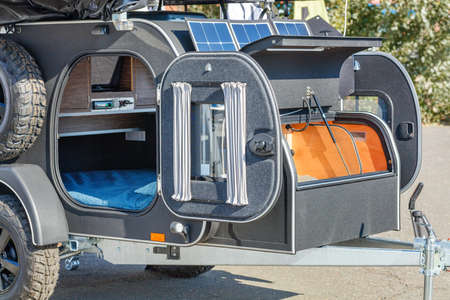 Compact camper, motorhome, trailer for a romantic road trip and a free life illuminated by summer...
