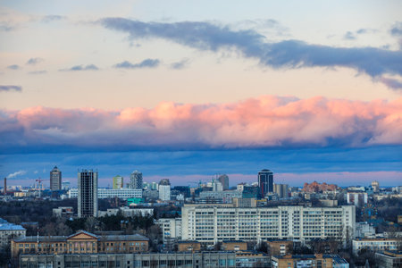 Colorful sky and clouds at sunset and twilight against the background of the urban evening landscape.の写真素材