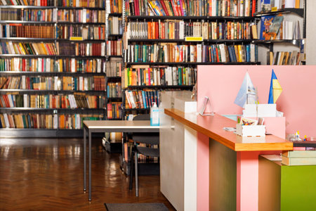 The receptionist's desk in the old library against the backdrop of bookshelves in blur. Copy space.