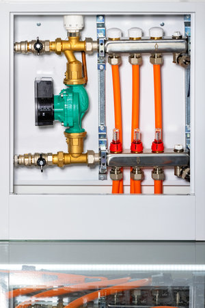Heating system control unit with circulation pump, inlet manifold with micrometric shut-off valves.