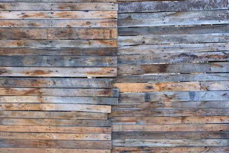 A rustic weathered horizontal backdrop wall of raw wood slats.の写真素材