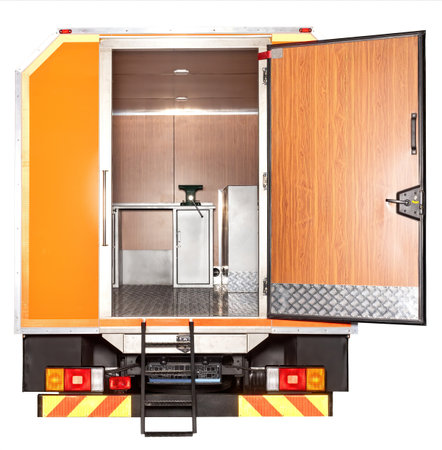 Mobile food truck interior view with rear door open, showcasing stainless steel surfaces and kitchen equipment, culinary workspace conceptの写真素材