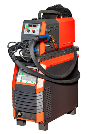 This robust welding machine stands poised for action, featuring advanced controls and hoses, ready to tackle industrial projects with precision and efficiency in a busy workshop atmosphere.の写真素材