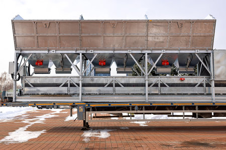 Aggregate hoppers for sand, screenings, and crushed stone of the ready-mix concrete mixing plants are mounted on a special frame.の写真素材