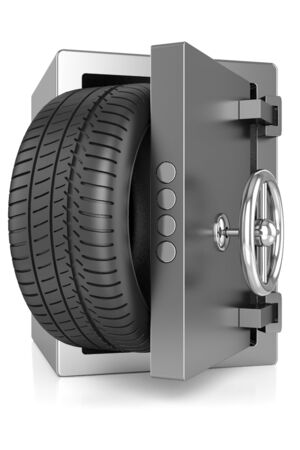 metal safe and a car tire isolated on white backgroundの写真素材