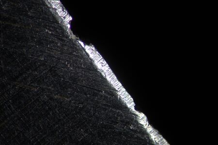 Cold steel razor blade by microscope. Microscopic scratched steel surfaceの写真素材