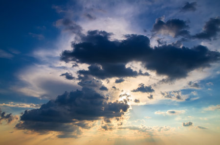 Dramatic sky with cumulus clouds at sunset.
