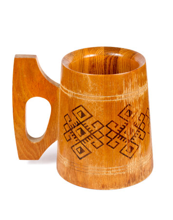 Wooden mug on a white background. Antique wooden mug with ornament.の写真素材