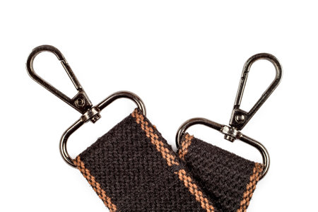 Two carbines on the belts. Metal carabiners on a white background.