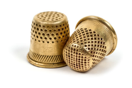 Antique copper thimbles for sewing. Close-up items on a white background.の写真素材