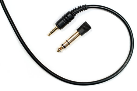 Headphone cable with 3.5 mm jack and 6.3 mm adapter. Close-up gold plated audio jacks.の写真素材