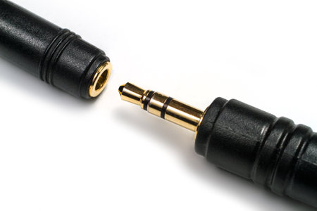 3.5mm jack on white background. Plug and socket for connecting stereo headphones.の写真素材