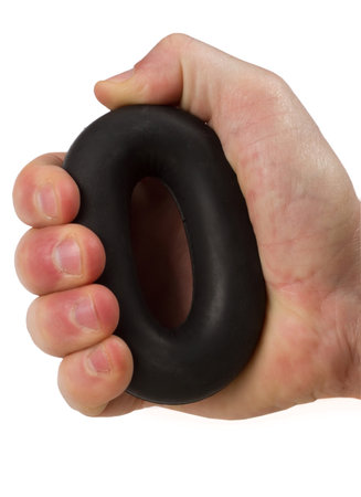 A man's hand squeezes a rubber wrist expander. Sports training of the strength of the hand.の写真素材