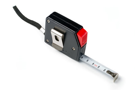 Measuring tape measure on a white background. Black measuring tape measure in a plastic case with a red button.の写真素材