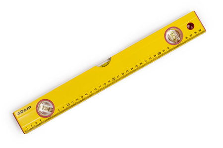 Ruler with a building level on a white background. Modern construction level close-up.