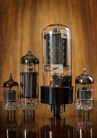 Vintage radio tubes on a background of wood.