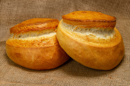 Breads. Two round loaves of bread against the background of burlap.の写真素材