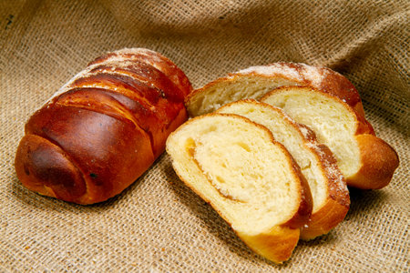 Bakery products close-up. Sweet bun with jam. Whole and sliced bun on the background of fabric.の写真素材