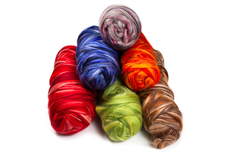 Coils of multi-colored yarn on a white background. Wool yarn in bright colors.