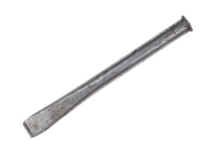 An old steel chisel on a white background. An iron chisel close-up.