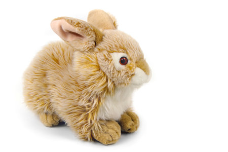 A toy hare on a white background. Stuffed toy plush hare. Fluffy red rabbit.の写真素材