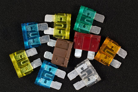 Car fuse close-up. Multi-colored fuses on a black background.