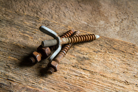 Old screw on wood background. Rusty fasteners close-up.の写真素材