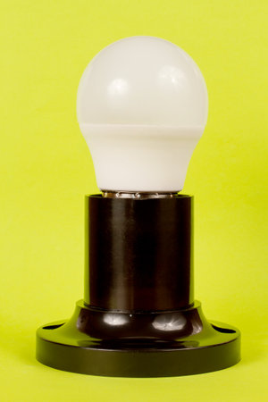 Energy-saving LED lamp in the socket on a green background. Close-up electric lamp.の写真素材