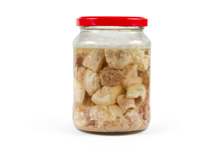 A can of canned meat. Homemade stew in a glass jar on a white background.の写真素材