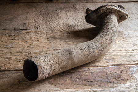 A rusted part of the car's exhaust system. Severed muffler pipe.の写真素材