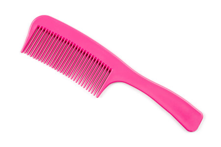 Pink comb with a handle on a white background. Simple plastic comb.の写真素材