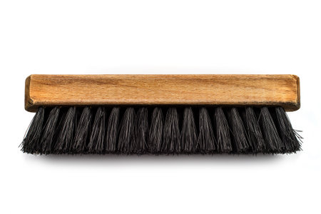 Wooden brush for cleaning clothes on a white background. Brush with black bristles.の写真素材