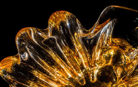 smooth glass surface. Abstract texture of orange glass on a black background.の写真素材