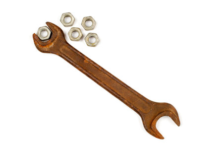 Old wrench with nuts on a white background. Rusty wrench on a white background.