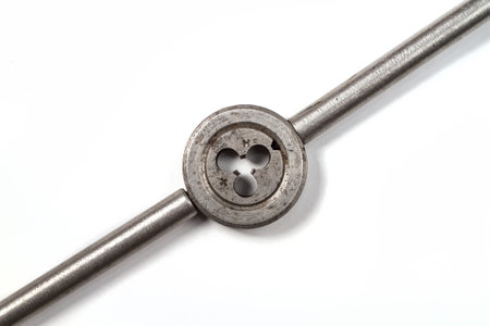 Threading dies. The die is fixed in a special holder. Subject on a white background.