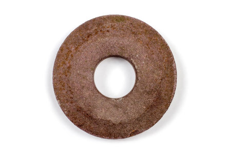An old sandstone on a white background. Close-up grinding wheel.の写真素材