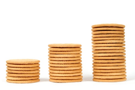 Columns of different heights made of cookies on a white background. Stacks of cookies isolated on a...