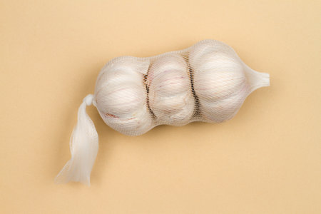 Garlic packed in a vegetable net. Fresh garlic in the package.