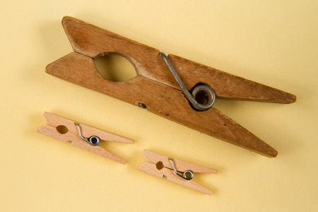Wooden clothes pins on a yellow background. view from above.の写真素材