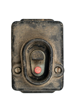 An old switch with a Start button. An old dirty switch on a white background. Powerful electrical...