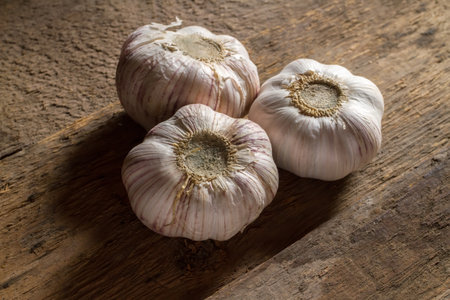 Heads of garlic on wooden boards. Fresh garlic on the background of rough boards.の写真素材