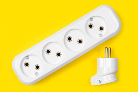 Electrical outlets and electrical plug on a yellow background. New electrical equipment close-up.