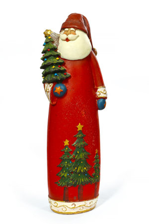 Decorative candle in the form of a figure of Santa Claus on a white background. Christmas figurine with a Christmas tree.の写真素材