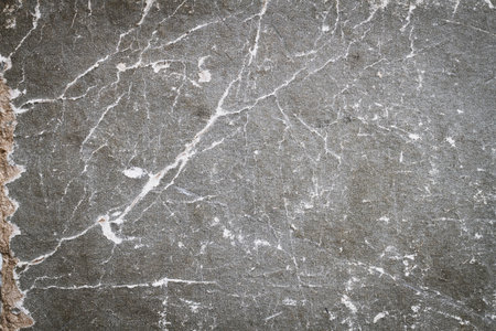 Gray grainy texture with cracks and scratches. Old frayed texture. Gray background.の写真素材
