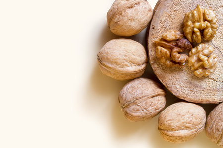 Walnuts on a beige background. Composition of walnuts and natural wood.の写真素材
