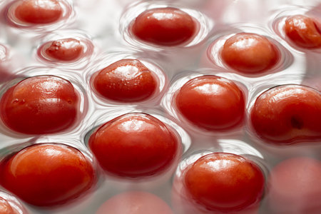 Compote of natural cherries. Canned fruit. The surface of the compote with cherries.の写真素材