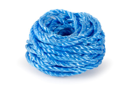A skein of synthetic blue rope on a white background. Close-up of nylon rope.