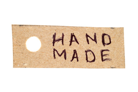Cardboard label with hand-made inscription Hand made. The label is isolated on a white background.の写真素材