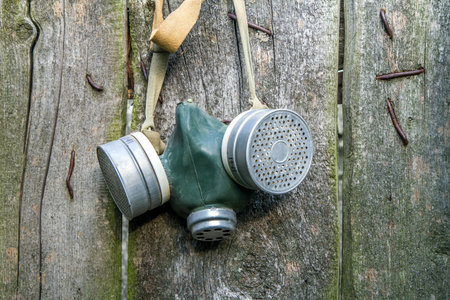 An old gas mask on rough boards. Gas mask with filters. Environmental pollution.の写真素材